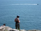 Preparing to rappel down over the water at Great Head