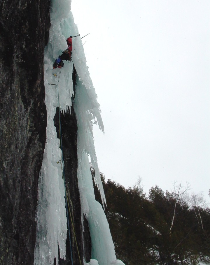 At the top, the ice overhangs; the route finishes by mounting the free-hanging pillar to the right