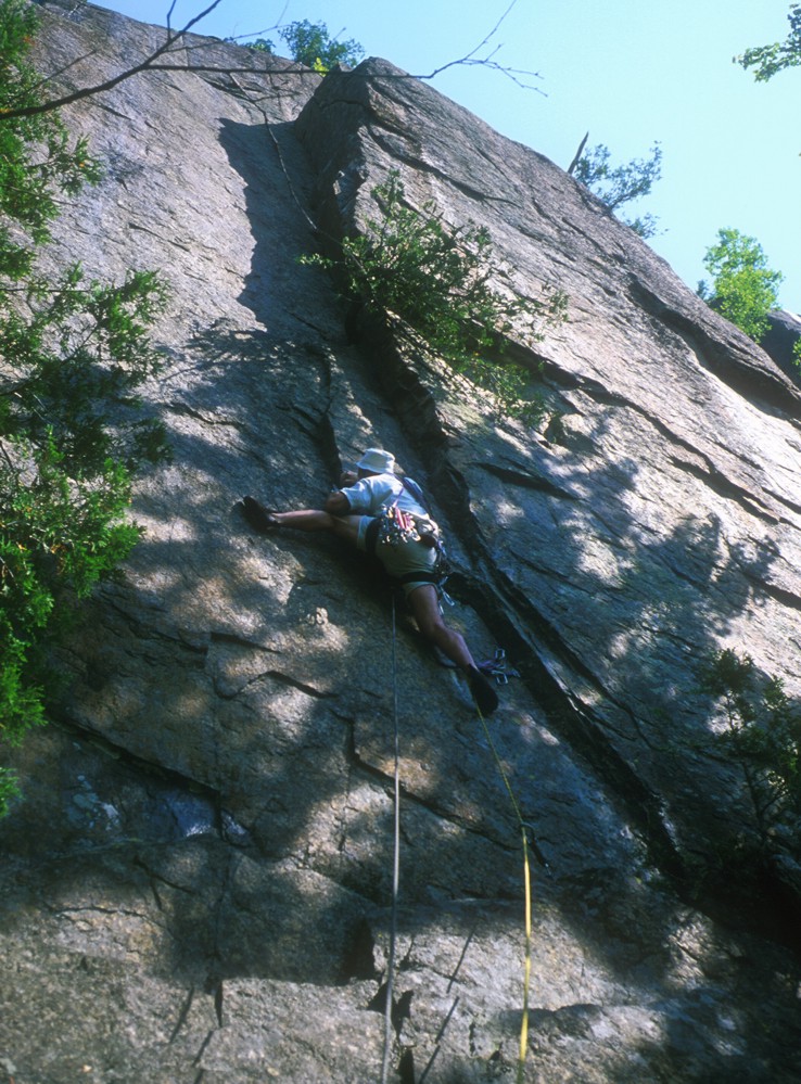 Kevin doing a split at the crux of Falconer