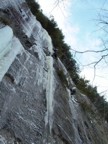 Moving up the final overhanging smear of ice at the top of the route; the crux of the route is the traverse connecting the pillar of Bubba to the yellow drips on the right