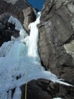 Climbing the crux column low on the route