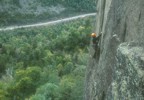 Getting established in the hand crack at the end of the traverse on the second pitch (5.11a)