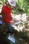 Lucie painting at the Washbowl Cliff, below the route Flashdance