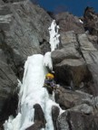 Jeremy climbs the initial ice bulge, using nuts on the right for protection