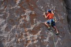 Easy face climbing on plates with cool orange lichen