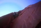 Casey climbs the sustained big-hands crack on the first pitch; the route climbs  through the roof above, then underclings right on slippery calcite