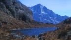 Looking east over an alpine lake at an impressive granite face