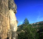 Jen pulls the high crux through the bulge near the top of the route