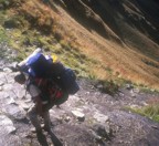 Approaching Abra de Warmiwausqa (Dead Woman Pass) at 4200m, a porter struggles under an enormous load of gear that tourists refuse to carry; this is the highest point on the Inca Trail