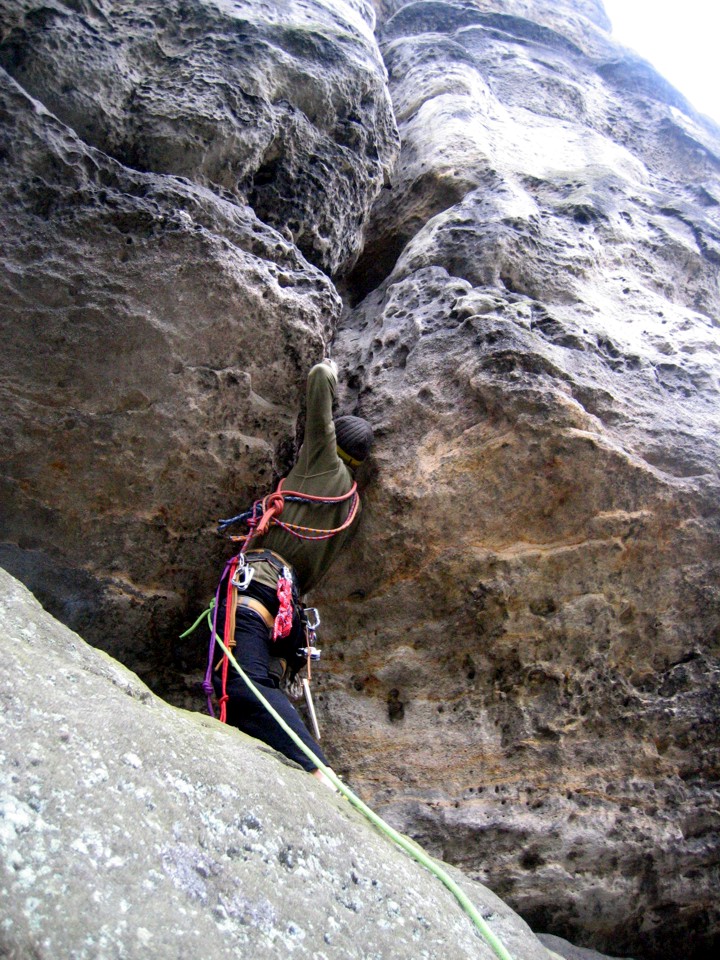 Making the crux moves at the start of the route -- an overhanging offwidth crack protected by jammed knots, the first knots I placed in Elbsandstein