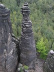 Unknown climber peering down from the top of a neighboring tower