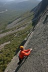 Climbing the slab below the overlap on the 5th pitch