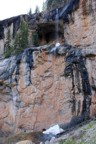 Two-tiered waterfall with a spooky mine shaft at the base