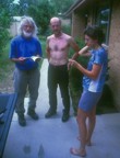 Nikos, Fanni, and Tom standing on driveway discussing routes