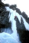 Climbing the thin column on Omega; the ice was running with water