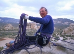 Eric belaying at the top, construction in the background