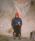 Lucie avoids the wind by sitting in a rock alcove