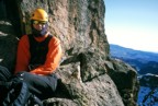 Sitting at a belay high on the route