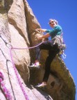 Climbing easy features through the roof on the second pitch of Bob Til You Drop