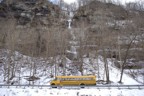 Joe climbs the upper column of Lock Tender as a school bus drives by