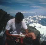 Examining the summit register on Shuksan