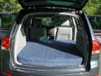 The bed seen from the rear of the vehicle with the homemade futon