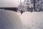 Clearing snow between the house and the garage on a typical snow year