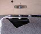 The bed sits on a platform that is attached to the floor using the existing seat bolt holes. This was accomplished using a metal plate and some washers.