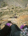 Jim leading the crux pitch, looking down at Nikos at the belay ledge