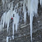 From the top of the ice column, Bones mounts the ice and climbs into a small ice cave to rest