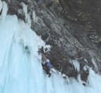 Chris reaches the first bolt on top of the steep ice on the second ascent; the route continues to the right onto a ledge (the one with the icicles), then pumps through three large roofs to the rim
