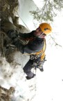 At the top of the ice, Griz chokes up on his tool, clips the bolt on the right, then proceeds through the rock band