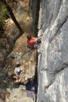 On the east face of South Peak, Jeremy climbs through the crux of Castor, belayed by Joe