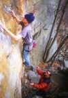 Chris boulders the opening moves on the direct start of Scary Area; Bones offering support from below