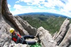 Finally in the sun, Colin enjoys a comfy belay at the end of P1