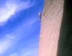 The route traverses the face, finally emerging on the arete at the skyline