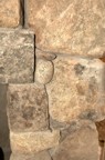 Stonework on the right side of the wood storage cubby