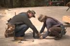 Doug and Nancy locate the metal brackets on which the posts rest