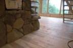 The hickory floor was carefully scribed around the stonework of the chimney