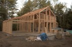 The completed timber frame is surrounded by stick-built 2x6 walls