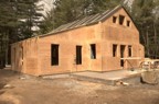 The Hut enclosed in plywood; the building finally begins to take form