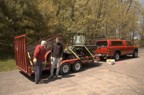 Jim and Jack load equipment onto the flatbed for transport to the Hut; this equipment was used to collect stones for the chimney from the property