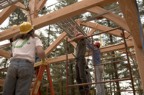 The "climbers" help position the scaffolding