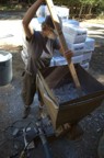 Katey helps break up the cellulose bales as they enter the hopper