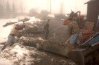 Erin and his son Zack move a large maple log onto the portable band mill