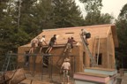 A large crew is required to lift the 10" stress skin panels onto the roof