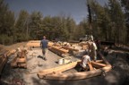 Bits of the timber frame are assembled on the ground before being raised