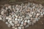 The collection of round stones gathered from the river for use in the chimney