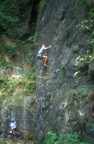 Climbing through the crux slab using small finger pockets