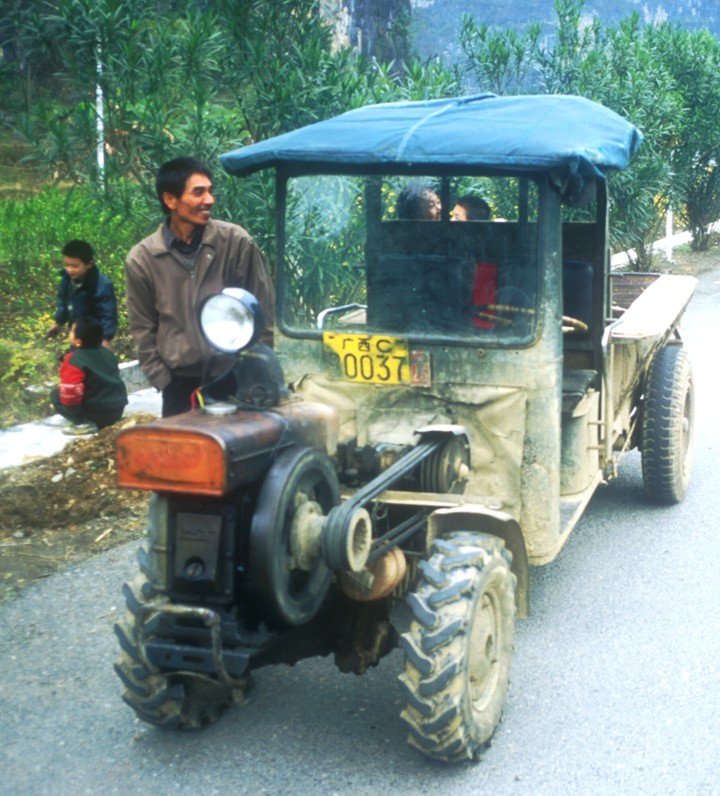 Typical transport in the countryside of Yangshuo; a cross between a tractor, and ATV, and a pick-up. Note the exposed fly-wheel in the front.